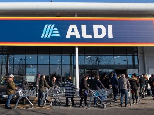 LONDON, ENGLAND - MARCH 23: Shoppers queue outside an Aldi supermarket on March 23, 2020 in London, England. Coronavirus (COVID-19) pandemic has spread to at least 182 countries, claiming over 10,000 lives and infecting hundreds of thousands more. (Photo by Dan Kitwood/Getty Images)