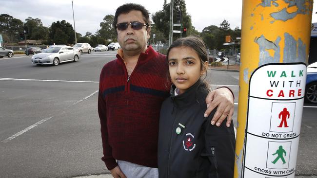 Alhad Harne with his 12-year-old daughter, Niharika, next to the pedestrian crossing where the girl was hit by a truck. Picture: David Caird