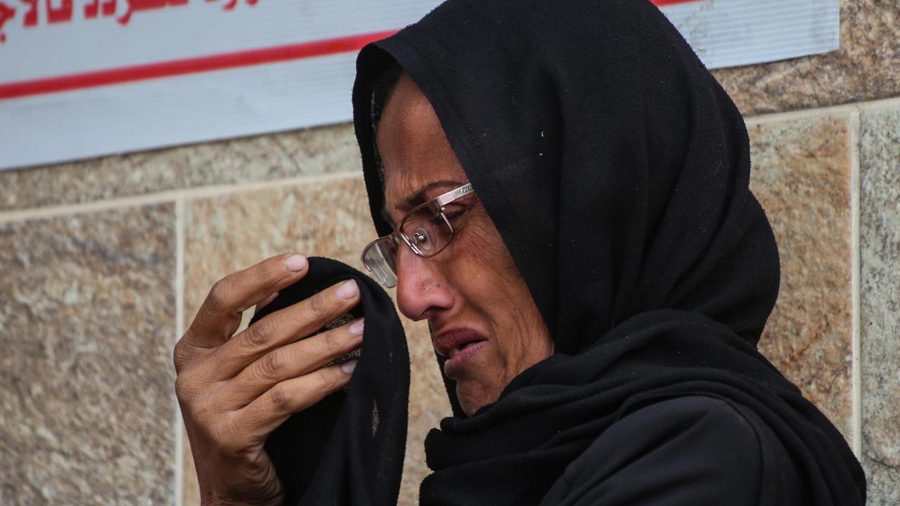 People mourn as they collect the bodies of Palestinians killed on December 23. Picture: Ahmad Hasaballah / Getty Images