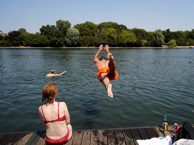 A man jumps into the Serpentine lake to cool off in Hyde Park, west London. Picture: Getty Images