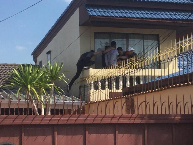 A Nigerian man believed to be linked to West African mafia operating out of Bangkok was caught trying to escape from a balcony. Picture: Supplied