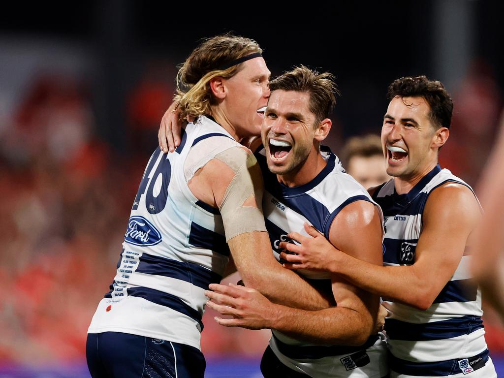 GEELONG, AUSTRALIA - APRIL 22: Tom Hawkins of the Cats celebrates a goal with teammates Mark Blicavs and Sam Simpson during the 2023 AFL Round 06 match between the Geelong Cats and the Sydney Swans at GMHBA Stadium on April 22, 2023 in Geelong, Australia. (Photo by Dylan Burns/AFL Photos via Getty Images)