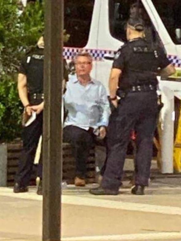 A photo obtained by the Townsville Bulletin shows Les Walker speaking with police.