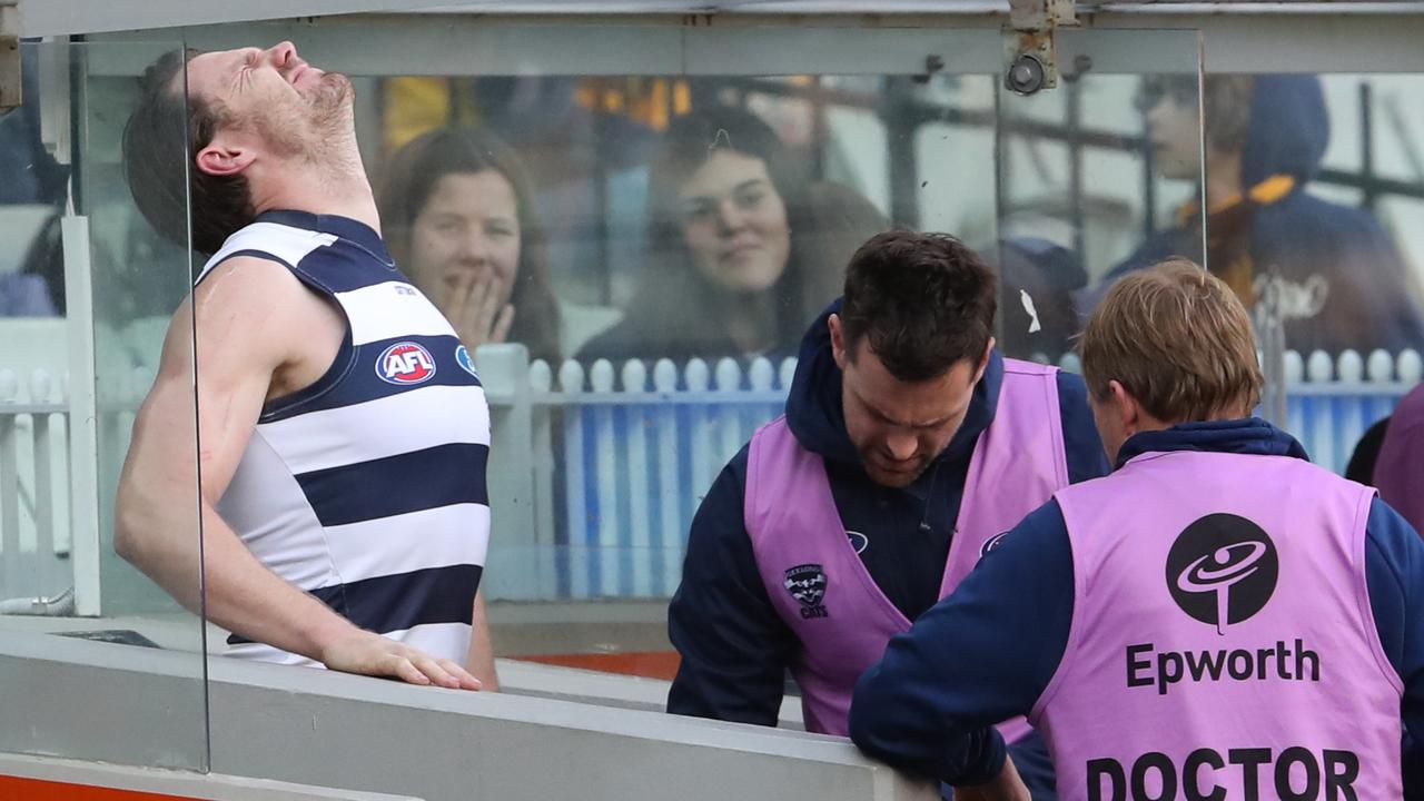 Geelong’s Patrick Dangerfield receives medical attention on the sidelines. (AAP Image/David Crosling)