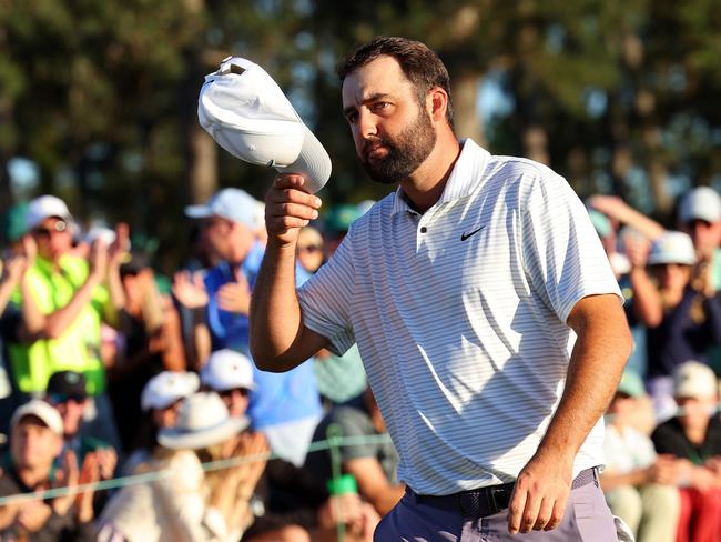 AUGUSTA, GEORGIA - APRIL 13: Scottie Scheffler of the United States tips his hat to the crowd on the 18th green after finishing his round during the third round of the 2024 Masters Tournament at Augusta National Golf Club on April 13, 2024 in Augusta, Georgia. (Photo by Andrew Redington/Getty Images)