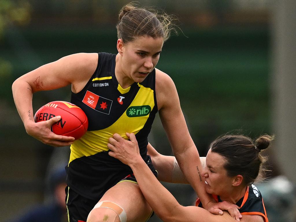 Ellie McKenzie of the Tigers fends off a tackle by Alyce Parker of the Giants. Picture: Quinn Rooney/Getty Images