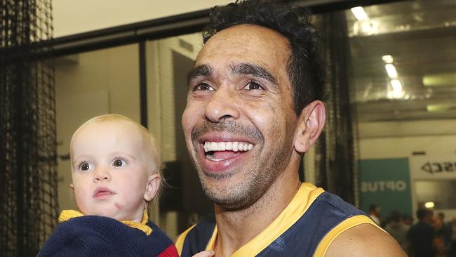 Eddie Betts with one of his twin daughters in the room after his 300th game. Picture SARAH REED