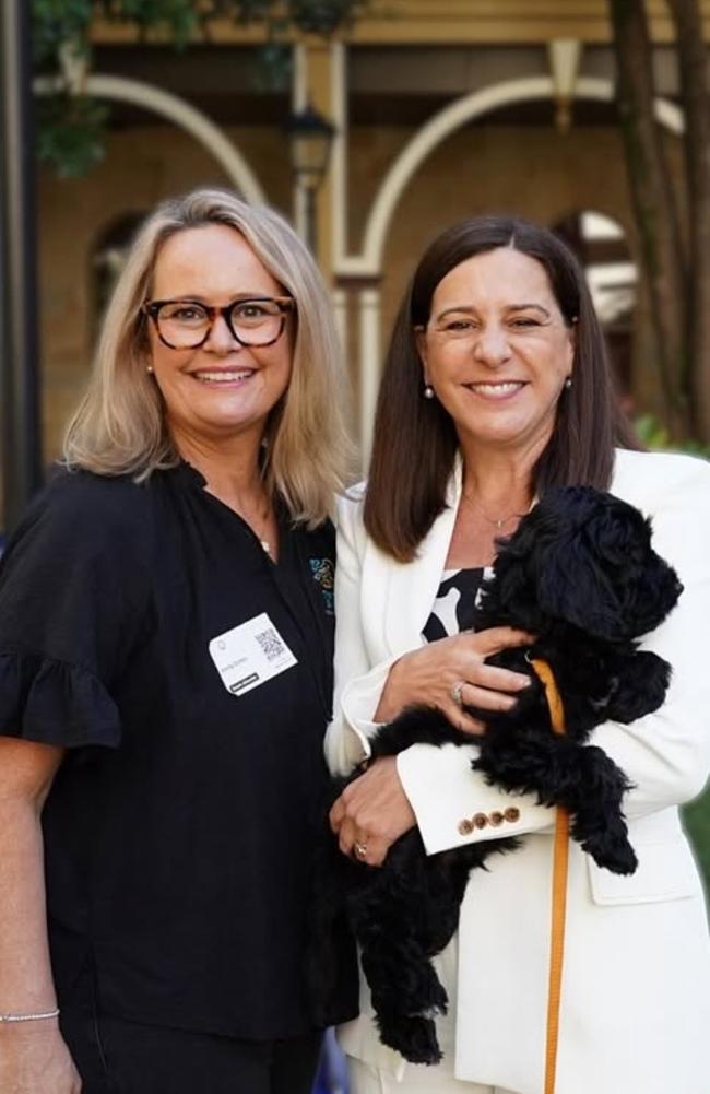 Kirilly Dutton pictured with Deb Frecklington holding a therapy dog during a Children's Hospital Foundation visit to Queensland Parliament.