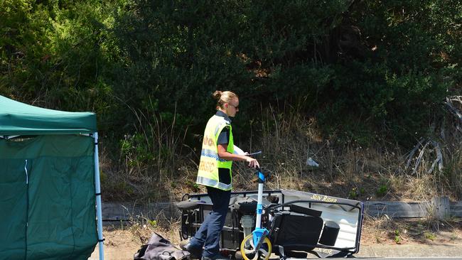 A policewoman at the site of a crash in Rosebud where a man died. Picture: Nicki Connolly