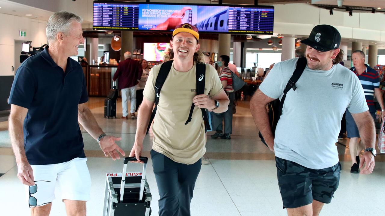 Australian golfer Cameron Smith, pictured with Australian manager Ian Davis, was all smiles after touching down in Australia. Picture David Clark