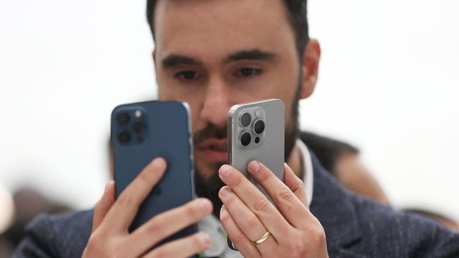 An attendee looks at the brand new Apple iPhone 15 Pro and iPhone 15 Pro Max. Picture: Justin Sullivan/AFP