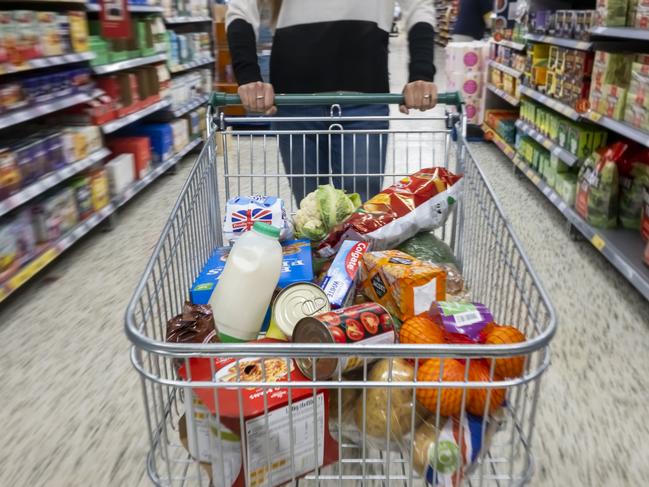 CARDIFF, WALES - MAY 22: A woman with a shopping trolley full of groceries in a supermarket aisle on May 22, 2022 in Cardiff, Wales. Last week, the UK Office for National Statistics reported an 6% average increase of food and drink prices year on year, but some staples, such as milk and pasta, had risen by more than 10%. (Photo by Matthew Horwood/Getty Images)