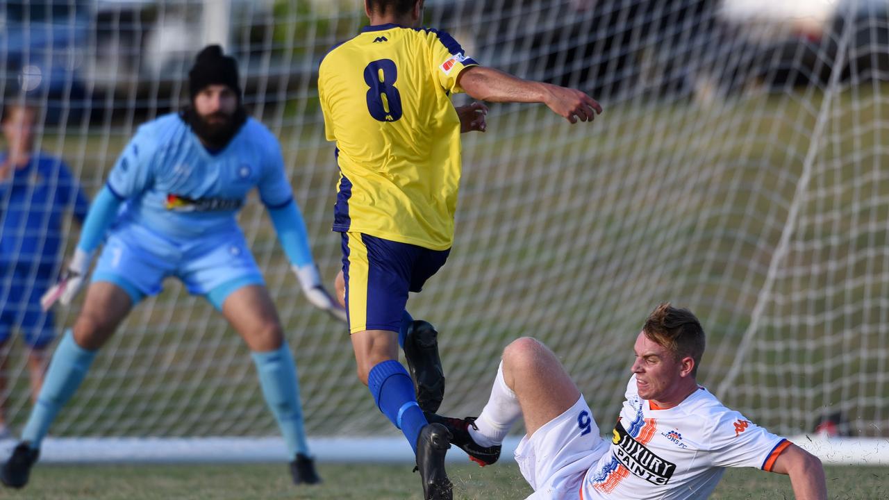 Lions FC’s Tommy Jarrard makes a tackle on Can Cuba. Picture: Steve Holland