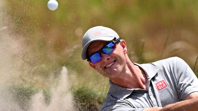 Australia's Adam Scott hits out of a bunker during the third round of the Australian Open (Photo by William WEST / AFP)