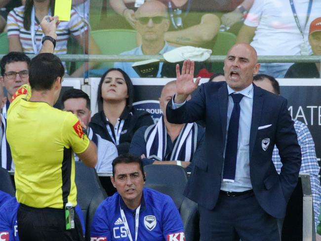 Referee Jarred Gillett gives Melbourne Victory coach Kevin Muscat a yellow card in February. Picture: AAP 