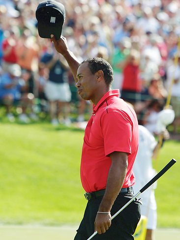 <p>Tiger Woods waves to the crowd after his birdie on the 18th. Picture: AP</p>