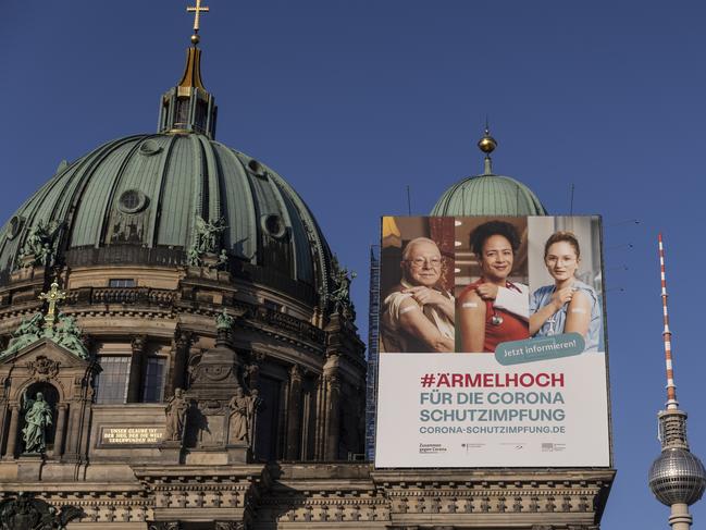 A poster promoting the vaccine hangs at Berlin Cathedral. Germany is in the midst of its third coronavirus wave that has been brought on by the spread of the B117 variant. Picture: Getty