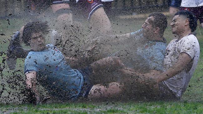 Muddy collision for NSW's Leo Bassingthwaighte and Harry Darling and Queensland's Al Nanai Marsden.