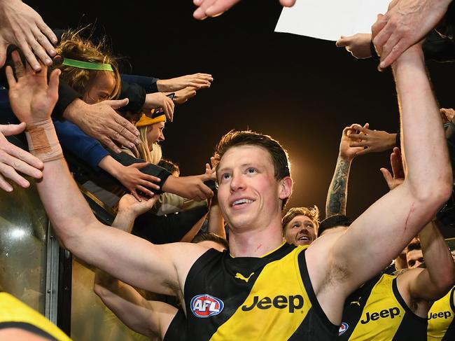 MELBOURNE, AUSTRALIA - SEPTEMBER 08:  Dylan Grimes of the Tigers  high fives fans after winning the AFL Second Qualifying Final Match between the Geelong Cats and the Richmond Tigers at Melbourne Cricket Ground on September 8, 2017 in Melbourne, Australia.  (Photo by Quinn Rooney/Getty Images)