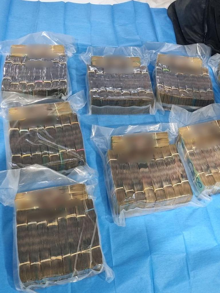 Stacks of cash worth $1M was also found at the Rocklea property. Picture: Queensland Police