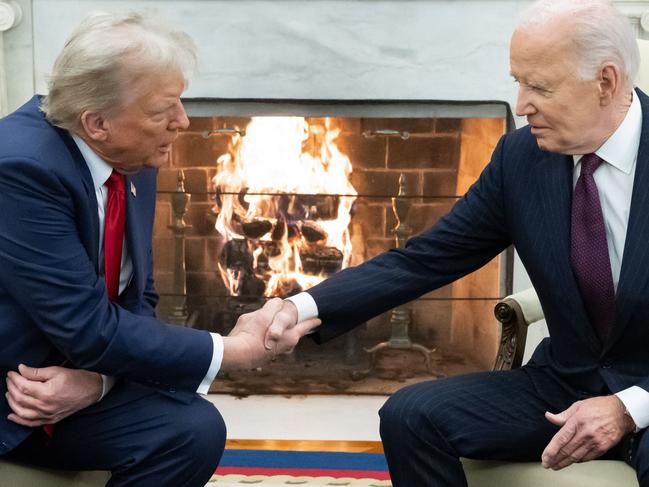 US President Joe Biden shakes hands with US President-elect Donald Trump during a meeting in the Oval Office of the White House in Washington, DC, on November 13, 2024. (Photo by SAUL LOEB / AFP)