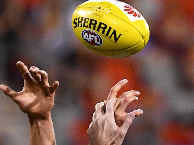 Generic picture of hands competing for the ball during the round 5 AFL match between the Gold Coast Suns and the North Melbourne Kangaroos at Metricon Stadium on the Gold Coast, Saturday, April 23, 2016. (AAP Image/Dave Hunt) NO ARCHIVING, EDITORIAL USE ONLY