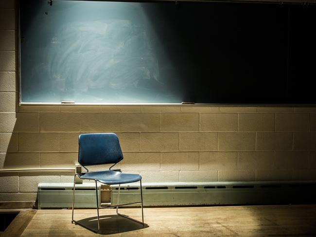 An Empty Chair in a Dark Classroom. Generic classroom, empty classroom, teaching, student, school. Picture: iStock