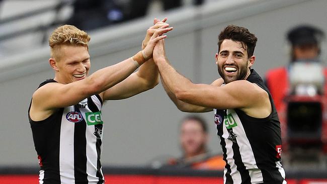 Alex Fasolo (right) kicks a goal against Geelong. Picture: Michael Klein