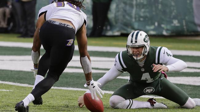 Baltimore Ravens wide receiver Chris Moore (10) recovers a botched snap by New York Jets punter Lac Edwards (4) during the first quarter.
