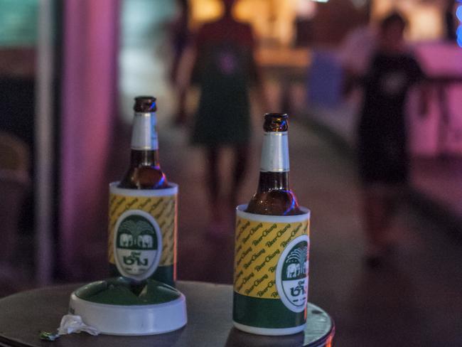 Bangkok, Thailand - April 30, 2011: Looking across a table at two bottles of Chang beer outside a beer bar in the Patpong area of Bangkok.