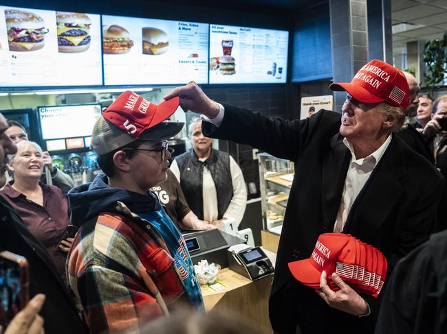 East Palestine, Ohio  - February 22 :  Former President Donald Trump, hands out MAGA hats and greets patrons during an off the record stop at a McDonald's restaurant during a visit to East Palestine, Ohio, following the Feb. 3 Norfolk Southern freight train derailment on Wednesday, Feb. 22, 2023, in East Palestine, Ohio. (Photo by Jabin Botsford/The Washington Post via Getty Images)