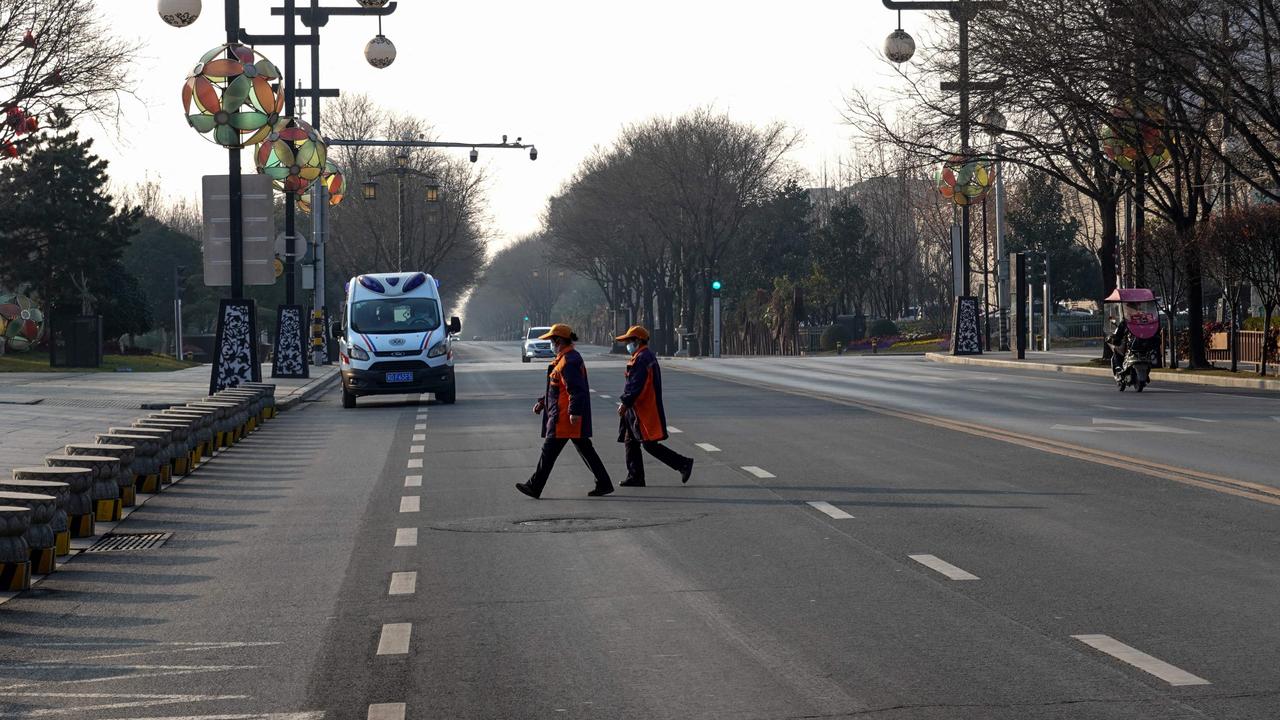 People cross a road in Xi'an in China's northern Shaanxi province. Picture: AFP /China OUT