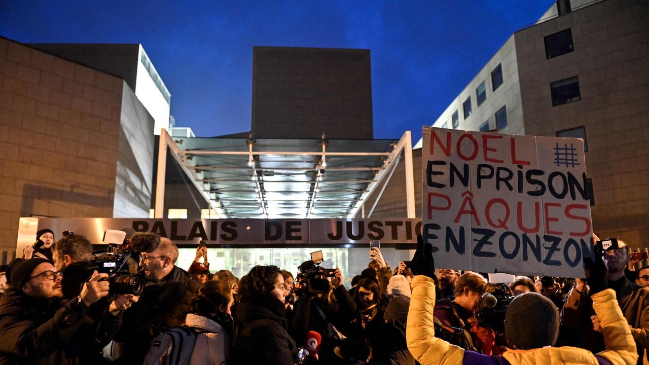 A feminist activist holds up a placard reading in French "Christmas in Prison, Easter in jail". Picture: Sylvain THOMAS / AFP)