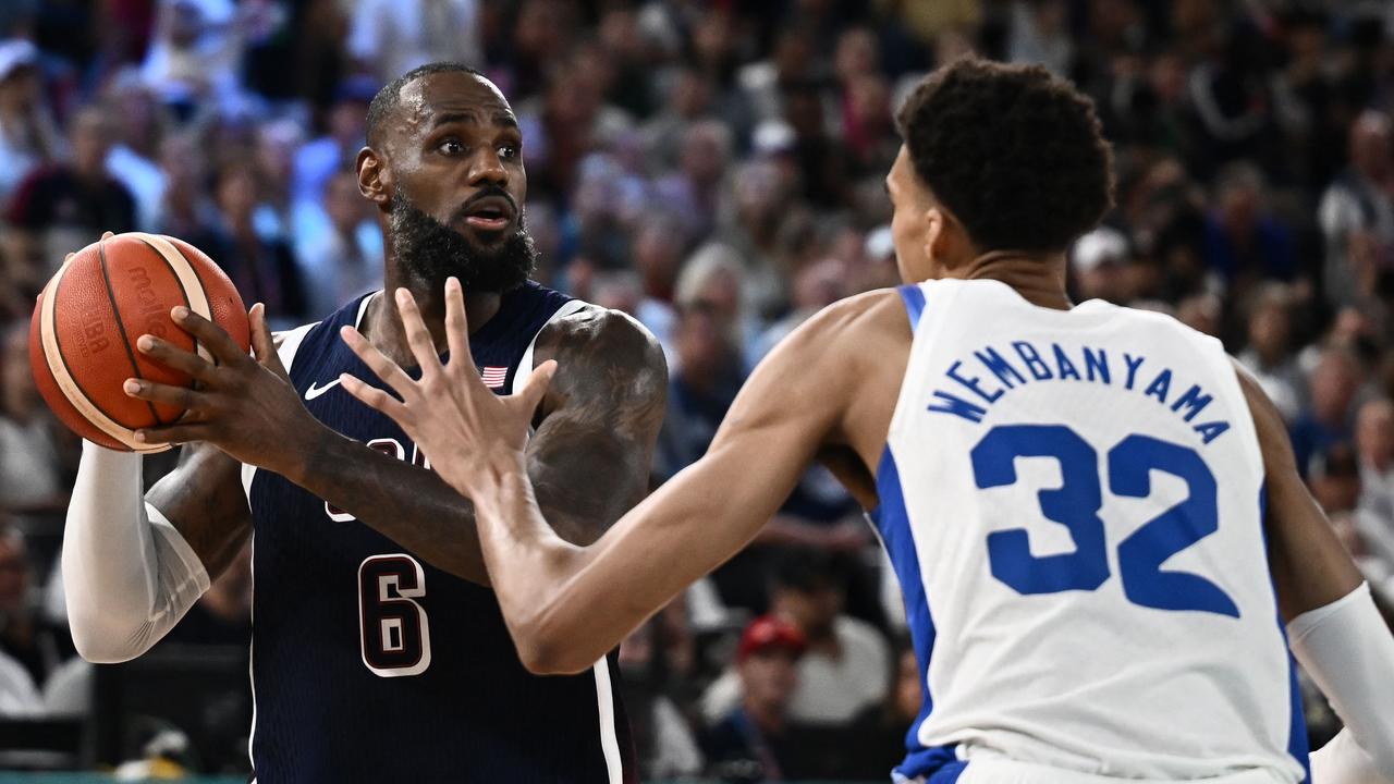 USA's LeBron James challenges France's Victor Wembanyama. Photo by Aris MESSINIS / AFP