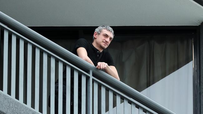 A man in quarantine standing on his balcony at the Hotel Grand Chancellor where new COVID-19 cases have been detected, Brisbane. Photographer: Liam Kidston