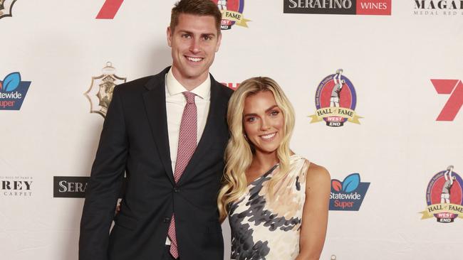 Michael Talia and Nicola Burgess wearing Alexis George pose for a picture on the red carpet at Adelaide Oval in North Adelaide, for the Magerey Medal, Monday, Sept. 9, 2019. Picture: MATT LOXTON