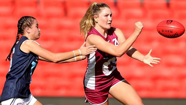 Alana Gee handballs during the Under 18 Girls Championship match between Queensland and Vic Metro at Metricon Stadium. Picture: Chris Hyde/AFL Photos.