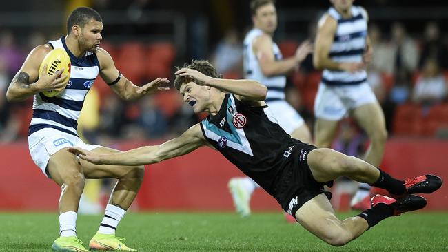 Geelong’s Brandan Parfitt tries to evade Port Adelaide’s Mitch Georgiades.