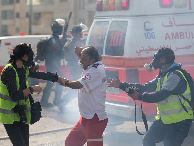 Danger zone ... A Palestinian medic reacts after he was pepper sprayed by an Israeli soldier during clashes near the Jewish settlement of Bet El, near the West Bank city of Ramallah.