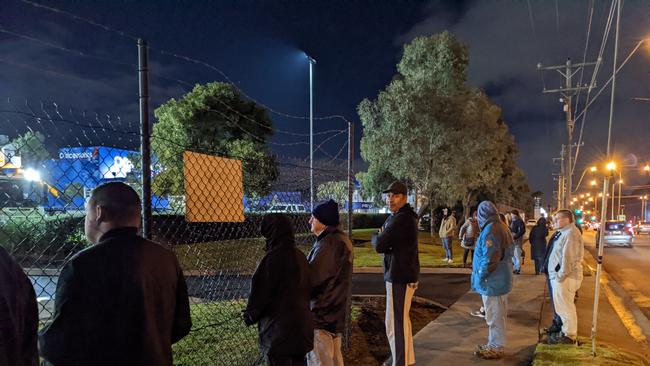 People line up at Wilson Transformers' gates to watch the superload leave Glen Waverley on July 14, 2022. Picture: Kiel Egging.