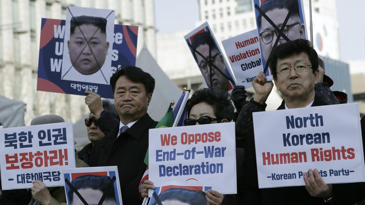 South Korean protesters and North Korean defectors hold portraits of leader Kim Jong-un during a rally urging the United States to discuss human rights issues. Picture: Lee Jin-man/AP