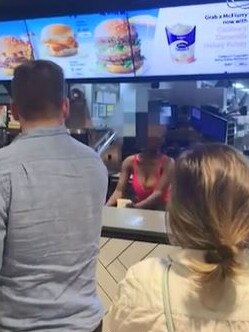 Screengrabs of the viral video, showing a woman taking food from the fridge.