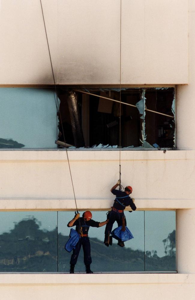 Police rescuers scale National Crime Authority (NCA) building in Waymouth Street, Adelaide after a parcel bomb explosion that killed Detective Geoff Bowen and lawyer Peter Wallis.