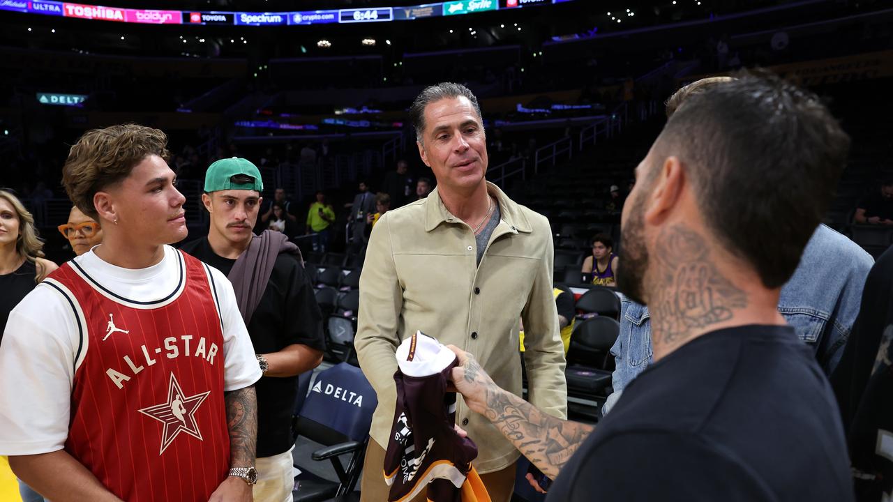 Reece Walsh, Kotoni Staggs and Adam Reynolds of the Brisbane Broncos talk with General Manager Rob Pelinka of the Los Angeles Lakers.