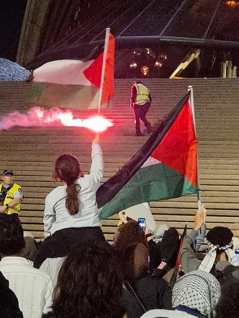 A flare was thrown at police, landing on the steps of the Opera House. Picture: News.com.au / Jasmine Kazlauskas