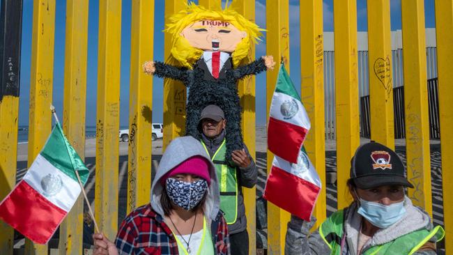 Protesters near the border wall in Playas de Tijuana, Mexico. Picture: Guillermo Arias/AFP