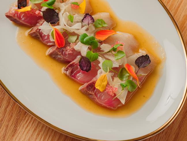 Raw Hiramasa kingfish with ginger, green chilli and finger lime. Picture: Dexter Kim
