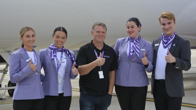 Bonza CEO Tim Jordan (centre) with members of the cabin crew at the first flight by the carrier from Melbourne to Toowoomba Wellcamp Airport in 2023.