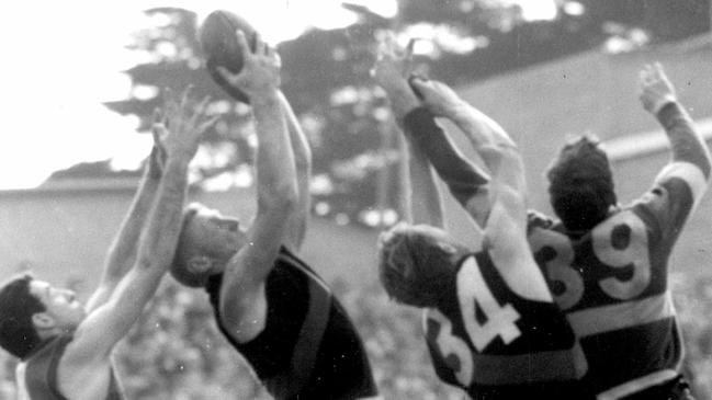 Ian Shelton takes a strong mark in front of Footscray’s Bob Spargo while teammate Brian Sampson competes with Bob Gray in front of him.