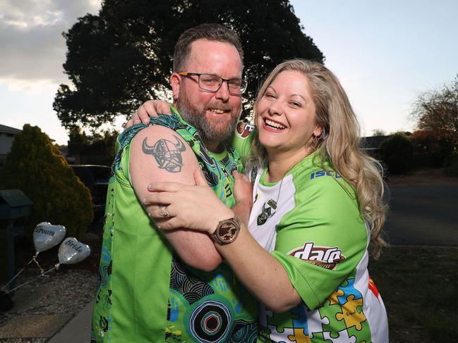 Newlyweds Dan and Jacqui Hewitt at home in Canberra dressed in thier Raiders fan gear. Picture Gary Ramage